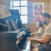 Abigail Terrill, playing an alternatively sized keyboard, and duo partner James Morris rehearse together